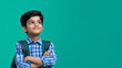 © UniqGraphicX - Smiling Indian teen school boy in school uniform crossed arms.
