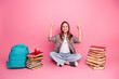 © deagreez - Cheerful young schoolgirl posing with books and backpack against a pink background