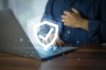 businessman working on a laptop with advanced cyber security shield, ensuring the protection of sens