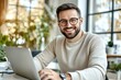 © Adobe Contributor - Smiling Caucasian Man Working on Laptop in Modern Workspace