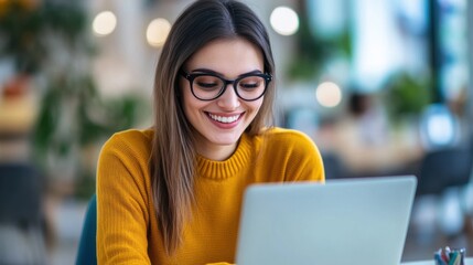 Aufkleber - Cheerful young professional woman in mustard-yellow sweater working at desk in modern office