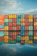 © Murda - Colorful shipping containers reflected in water.