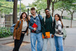 © Nuria Seguí/Stocksy - Smiling College Students With Backpacks And Books At Campus