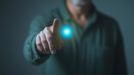 A man is pointing at a glowing blue button. Concept of excitement and anticipation, as if the button is a gateway to something new and exciting