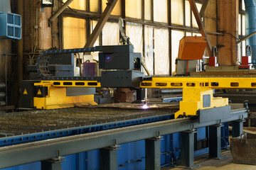 Fototapete - Modern industrial machinery performs laser cutting in an active workshop