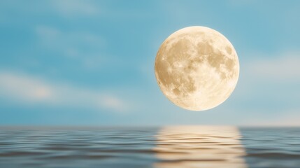 Poster - A full moon rising over the ocean with a blue sky in the background