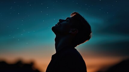 Wall Mural - a man is silhouetted against a dark sky with a few stars visible