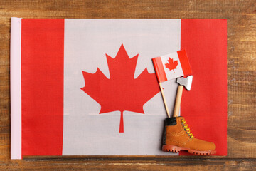 flag of canada with axe and lumberjack shoes. concept of traditional symbols of this country