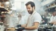 © NayaiP - Un chef cuisinier concentré prépare un plat savoureux dans une cuisine de restaurant animée.