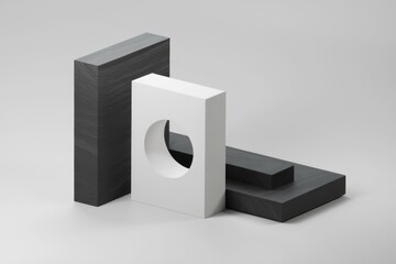 Poster - Abstract minimalist composition of black and white geometric shapes, showcasing a design concept with cut-out details.