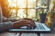 © letter - Close-up of hands typing on a laptop in a modern office with natural light for business work and online research