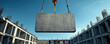 © Narongsak - A crane lifts a large concrete panel above a construction site, showcasing the progress of a building project under clear blue skies and exposed reinforcement bars.