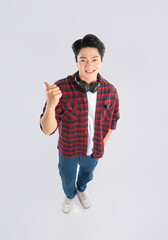 Wall Mural - Full body image of young dynamic Asian man posing on white background