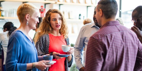 Wall Mural - group of diverse people in casual attire having a coffee break, chatting and enjoying coffee. social