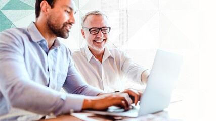 Cheerful web developers working on a laptop