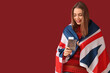 © Pixel-Shot - Beautiful young happy woman with UK flag, passport and ticket on red background