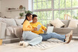 © Pixel-Shot - Young couple using laptop and tablet computer at home