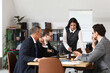 © Pixel-Shot - Female lawyer working with colleagues at table in office