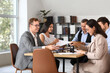 © Pixel-Shot - Group of lawyers working at table in office