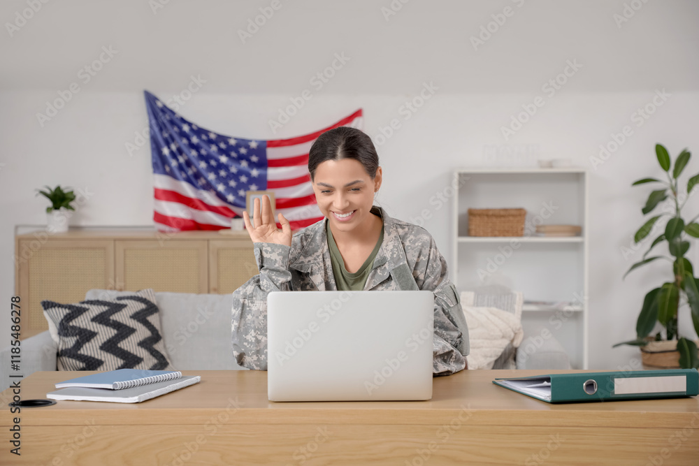 Female soldier with laptop video chatting at home