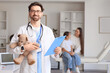 © Pixel-Shot - Male pediatrician with clipboard and toy bear in clinic