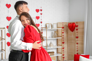 Canvas Print - Young couple in love hugging at home on Valentine's Day