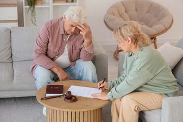 Wall Mural - Mature couple signing divorce decree at home