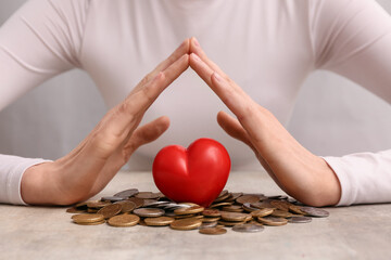 Wall Mural - Woman with red heart and coins on table