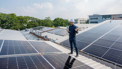 Wall Mural - Engineer service check installation solar cell on the roof of factory. Silhouette technician inspection and repair solar cell on the roof of factory. Technology solar energy renewable.