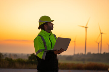 Wall Mural - engineer wearing uniform inspection and survey work in wind turbine farms rotation to generate elect
