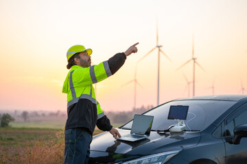 Wall Mural - engineer with laptop survey work in wind turbine farms rotation to generate electricity energy. main
