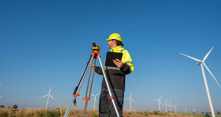 Wall Mural - survey in uniform alternative energy for future. engineers survey and checking wind turbines in suns