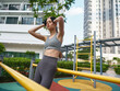 © SHOTPRIME STUDIO - Young woman exercising in an urban park setting, wearing a sports outfit and enjoying her workout routine