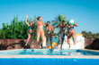 © Nanci - Mature friends wearing colorful swimsuits leaping into sunlit pool, laughing and enjoying summer vacation camaraderie with youthful energy and creating unforgettable memories together outdoors