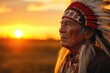 © kardaska - Native american chief wearing traditional headdress at sunset