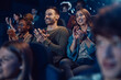 © Drazen - Happy audience applauding after movie premiere at cinema.