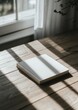 © CYBERPINK - A white book is sitting on a wooden table