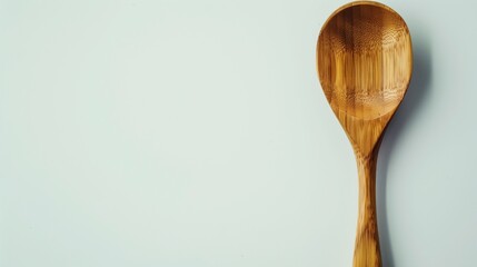 A single wooden spoon with a smooth, natural finish, isolated on a clean white backdrop.