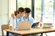 © Prathankarnpap - Medical students working together on assignments in a modern study space.