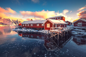 Wall Mural - lofoten islands, reine, norway and hamnoy fishing village with red rorbuer houses in winter sunset l