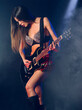© sumnersgraphicsinc - Sexy woman in short skirt playing electric guitar