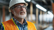 © InspirationDesign - Senior construction supervisor in safety gear. Great for industrial leadership, professional experience, and workplace safety themes.