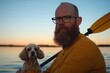 © Антон Сальников - A young male is out for a kayak adventure on the lake, accompanied by his playful spaniel, embracing a moment of freedom and companionship