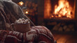 © Photo by mQ - A steaming mug of hot chocolate with marshmallows, nestled in a cozy armchair by a crackling fireplace. A blanket drapes over the chair, with warm browns, creams, and reds evoking cozy comfort