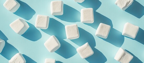 Leinwandbilder - Design of delicious marshmallows with strong shadows on a light blue backdrop. with copy space image. Place for adding text or design