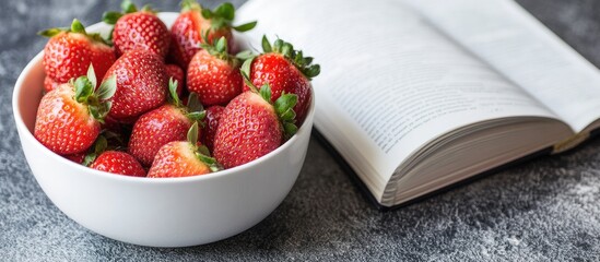 Aufkleber - Bowl of fresh strawberries alongside a white recipe book. with copy space image. Place for adding text or design