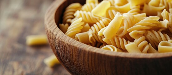 Leinwandbilder - Close up of pasta in a wooden bowl with copyspace