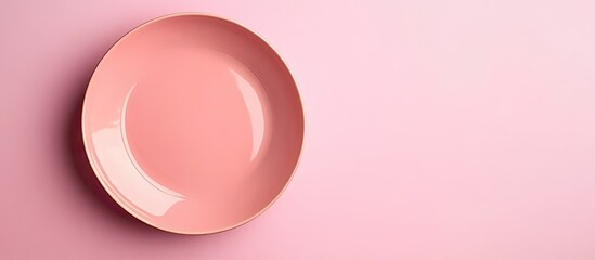 Fototapete - Top view of an isolated colored background with an empty round pink plate for food Blank dish with room for your design. with copy space image. Place for adding text or design