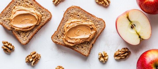 Fototapete - Close up of sandwiches with peanut butter and an apple on the table Apple slices and walnuts isolated against a white background Horizontal top view. with copy space image