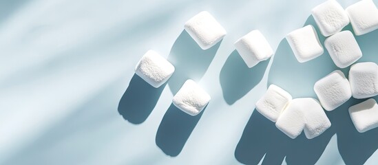 Leinwandbilder - Design of delicious marshmallows with strong shadows on a light blue backdrop. with copy space image. Place for adding text or design
